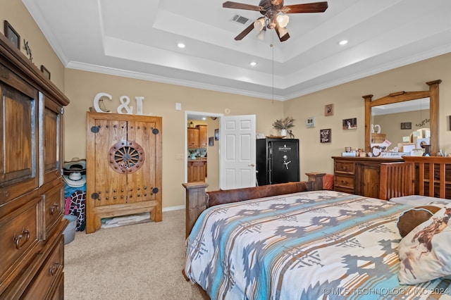 bedroom featuring crown molding, a tray ceiling, ceiling fan, and light carpet