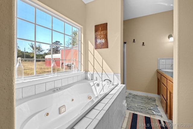 bathroom featuring tiled tub and tile patterned flooring