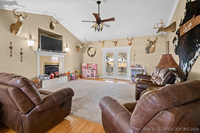 living room featuring ornamental molding, light hardwood / wood-style floors, a fireplace, and lofted ceiling