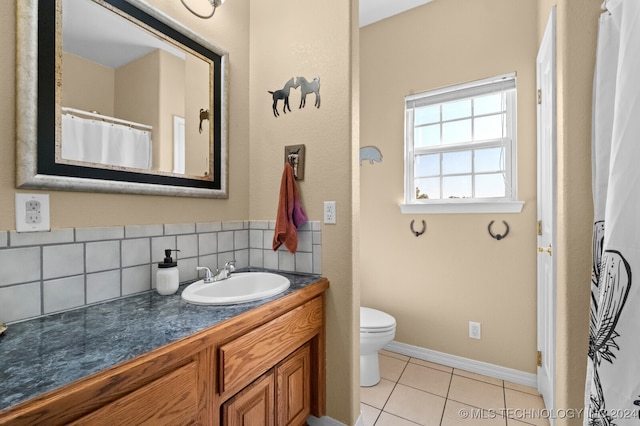 bathroom with tile patterned flooring, backsplash, vanity, and toilet