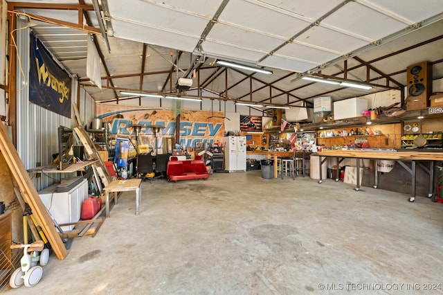 garage with a garage door opener and a workshop area