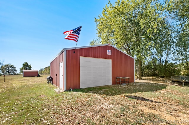 garage featuring a lawn