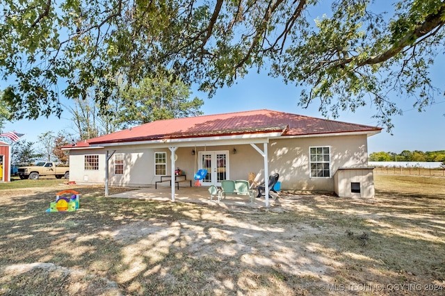 rear view of property with french doors and a patio