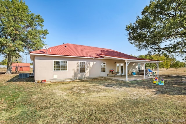 back of property featuring a lawn and a patio