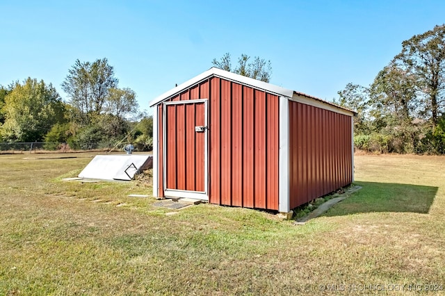 view of outbuilding featuring a yard