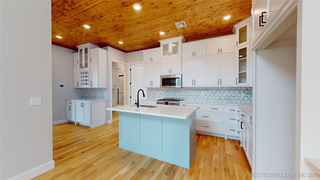 kitchen featuring white cabinets, sink, a kitchen island with sink, appliances with stainless steel finishes, and light hardwood / wood-style floors