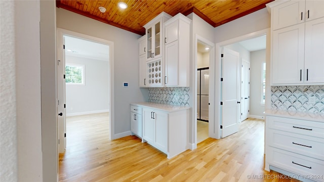 kitchen featuring wood ceiling and white cabinetry