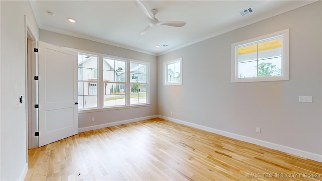 empty room featuring ceiling fan, light hardwood / wood-style flooring, and plenty of natural light