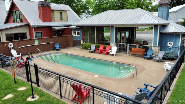 view of swimming pool with a patio area