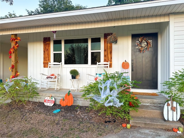 view of exterior entry with a porch