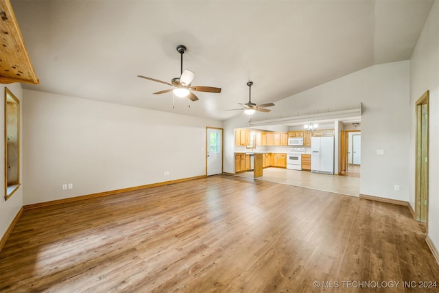 unfurnished living room featuring ceiling fan with notable chandelier, light hardwood / wood-style floors, and vaulted ceiling