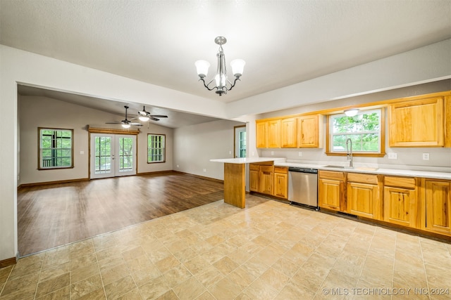 kitchen featuring a healthy amount of sunlight, stainless steel dishwasher, sink, and decorative light fixtures