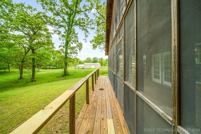 wooden terrace featuring a lawn