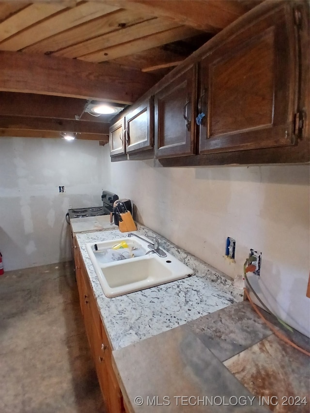 kitchen featuring wood ceiling and sink