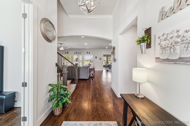 hall featuring ornamental molding and dark hardwood / wood-style flooring