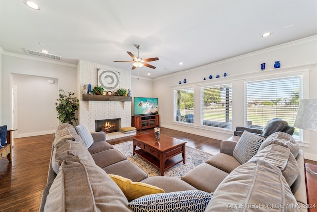 living room featuring crown molding, a healthy amount of sunlight, and dark hardwood / wood-style flooring