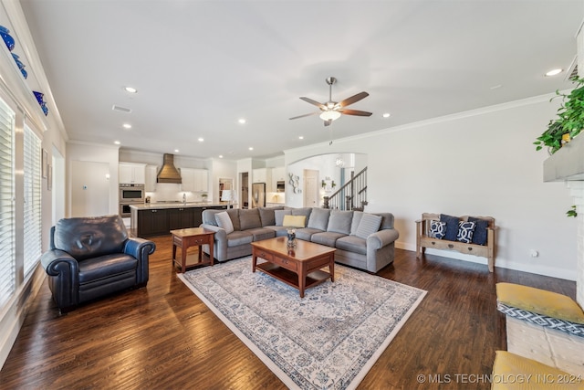 living room featuring ceiling fan, ornamental molding, and dark hardwood / wood-style flooring