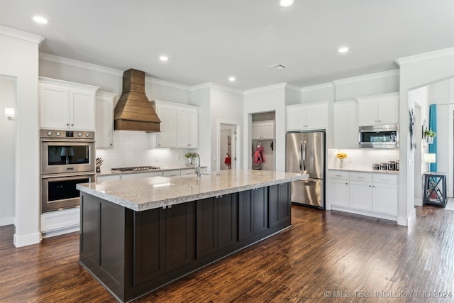 kitchen featuring stainless steel appliances, a center island with sink, dark hardwood / wood-style floors, and custom range hood