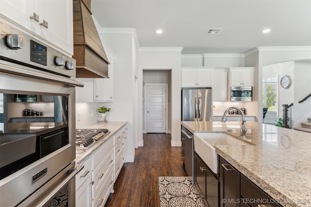 kitchen featuring light stone counters, dark wood-type flooring, sink, white cabinetry, and stainless steel appliances