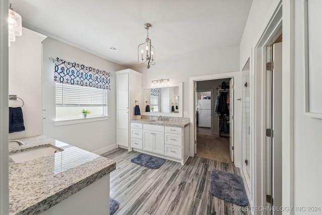 bathroom featuring walk in shower, vanity, a notable chandelier, and hardwood / wood-style flooring