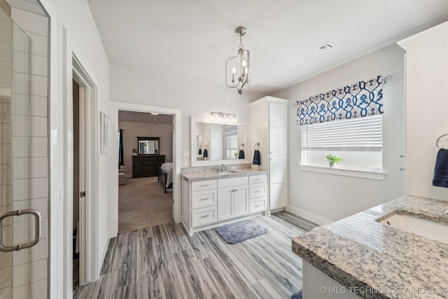 bathroom featuring vanity, a chandelier, hardwood / wood-style floors, and an enclosed shower