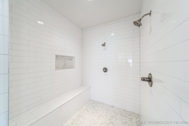 bathroom with tiled shower