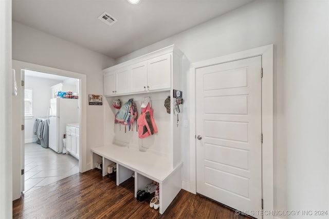 mudroom featuring dark wood-type flooring and independent washer and dryer