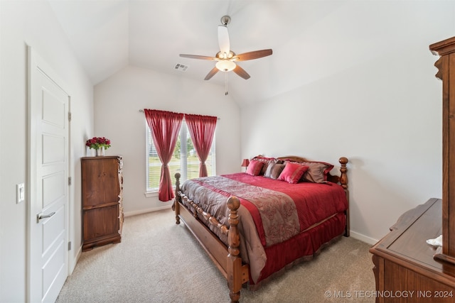 carpeted bedroom with ceiling fan and vaulted ceiling