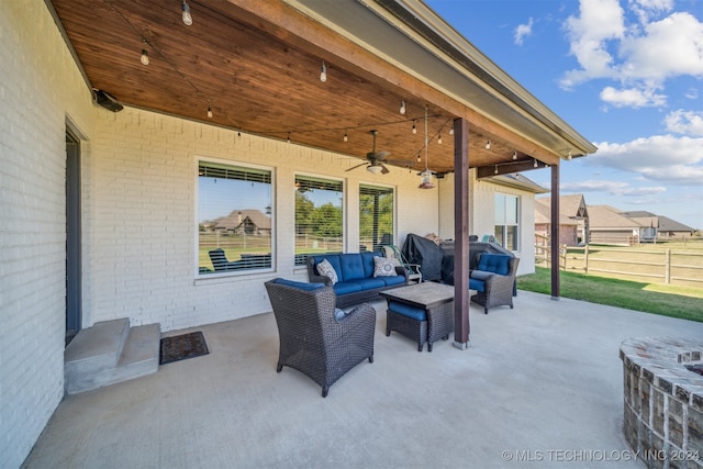 view of patio with an outdoor living space and ceiling fan