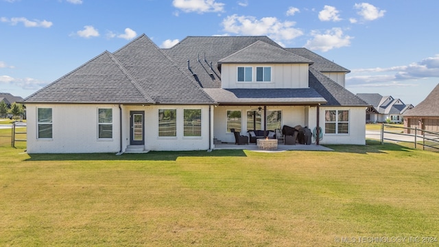 rear view of house featuring a patio and a yard