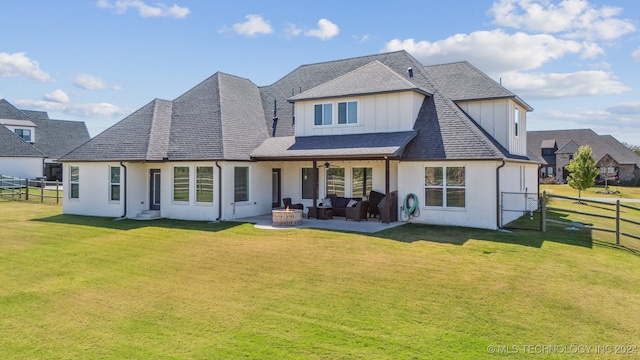 back of house with a lawn and a patio area