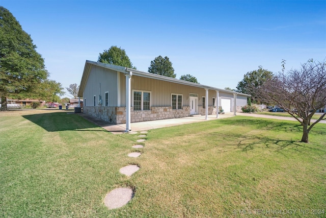 view of front of house with a front yard and a garage