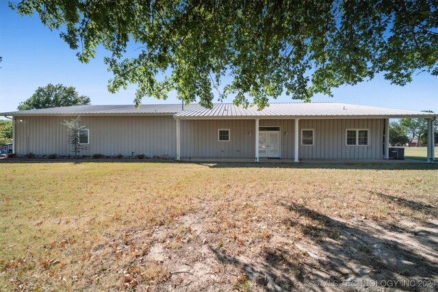 1202 SW 9th St, Wagoner, OK 74467 - view of front of house featuring board and batten siding, metal roof, and a front yard