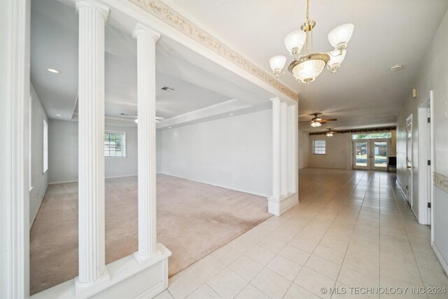 1202 SW 9th St, Wagoner, OK 74467 - entryway featuring plenty of natural light, ceiling fan with notable chandelier, ornate columns, and light colored carpet