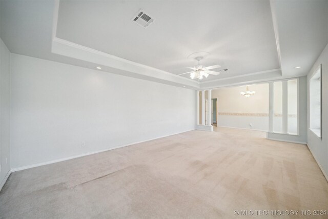 1202 SW 9th St, Wagoner, OK 74467 - empty room with visible vents, carpet, ceiling fan with notable chandelier, and a tray ceiling