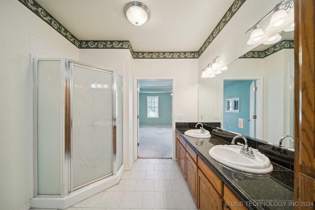 1202 SW 9th St, Wagoner, OK 74467 - bathroom featuring double vanity, a sink, a stall shower, and tile patterned floors