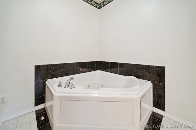 bathroom featuring a tub to relax in, tile patterned flooring, and tile walls