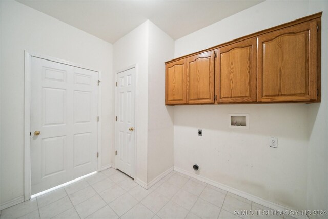 1202 SW 9th St, Wagoner, OK 74467 - laundry room with washer hookup, hookup for an electric dryer, cabinet space, baseboards, and light tile patterned flooring