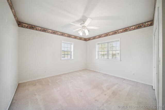 1202 SW 9th St, Wagoner, OK 74467 - unfurnished room with carpet flooring, ceiling fan, plenty of natural light, and baseboards