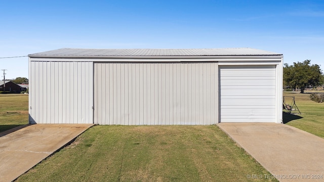 garage featuring a yard and wood walls