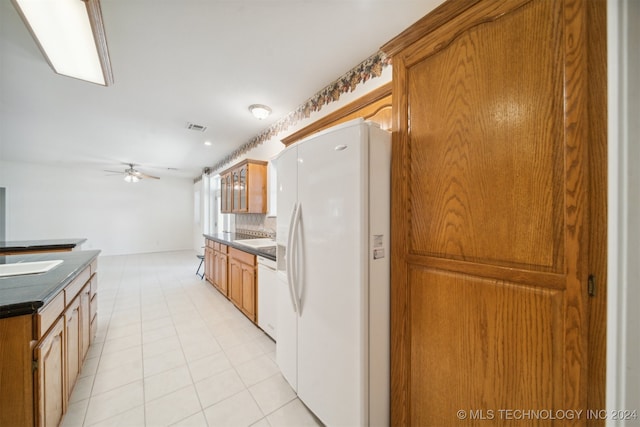 kitchen with backsplash, white appliances, ceiling fan, and light tile patterned floors