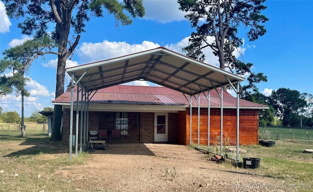 595 N 4340th Rd, Fort Towson, OK 74735 - view of outdoor structure featuring a carport, fence, and dirt driveway