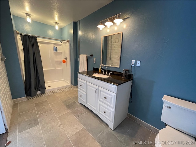 595 N 4340th Rd, Fort Towson, OK 74735 - full bath with a shower with shower curtain, vanity, toilet, baseboards, and stone finish flooring