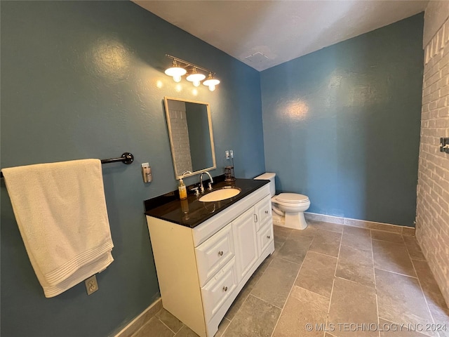 595 N 4340th Rd, Fort Towson, OK 74735 - bathroom with toilet, vanity, and baseboards