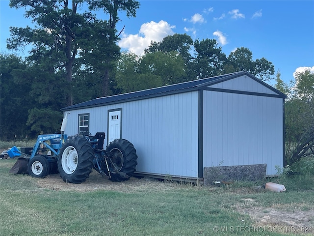 view of outbuilding featuring a lawn