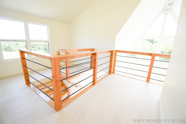 bonus room with lofted ceiling and light hardwood / wood-style floors