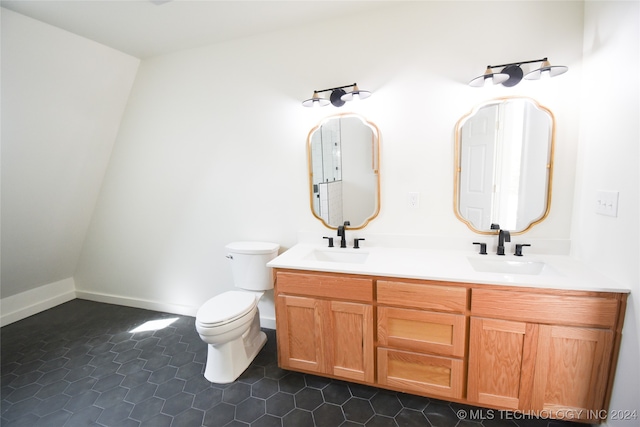 bathroom with tile patterned flooring, vanity, and toilet