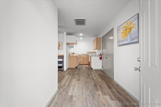 corridor with light hardwood / wood-style flooring