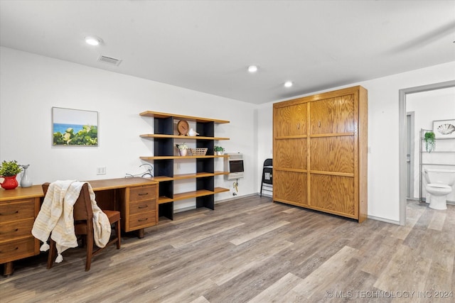 office featuring heating unit and light hardwood / wood-style floors