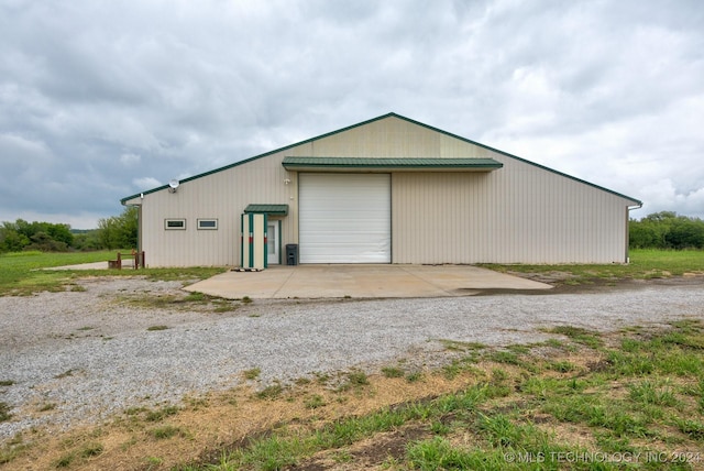 back of property featuring a garage and an outdoor structure